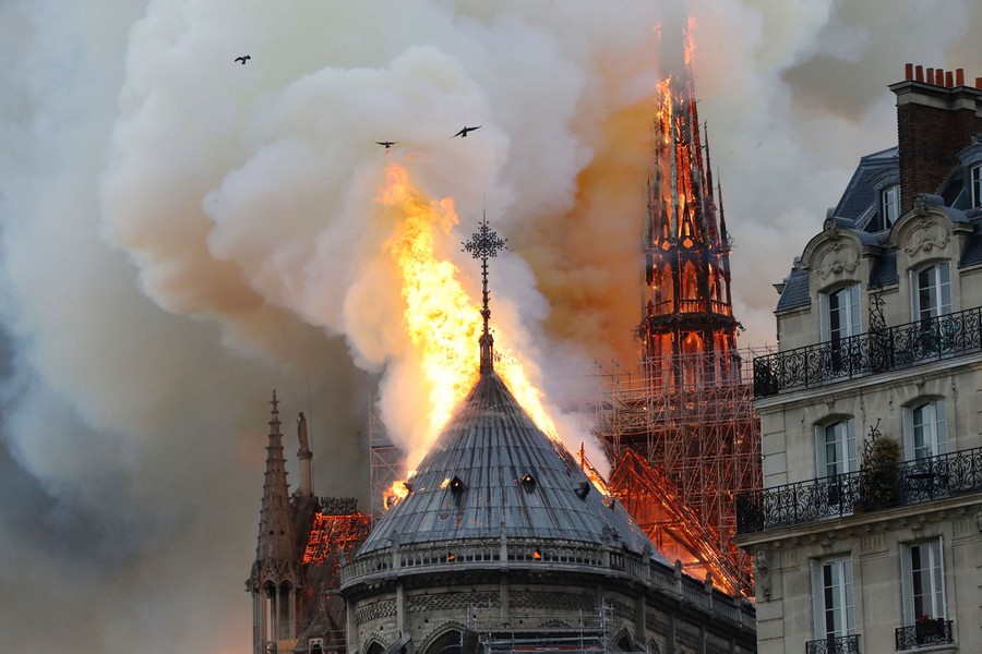 TOPSHOT - Smoke and flames rise during a fire at the landmark Notre-Dame Cathedral in central Paris on April 15, 2019, potentially involving renovation works being carried out at the site, the fire service said. (Photo by FRANCOIS GUILLOT / AFP)        (Photo credit should read FRANCOIS GUILLOT/AFP/Getty Images)